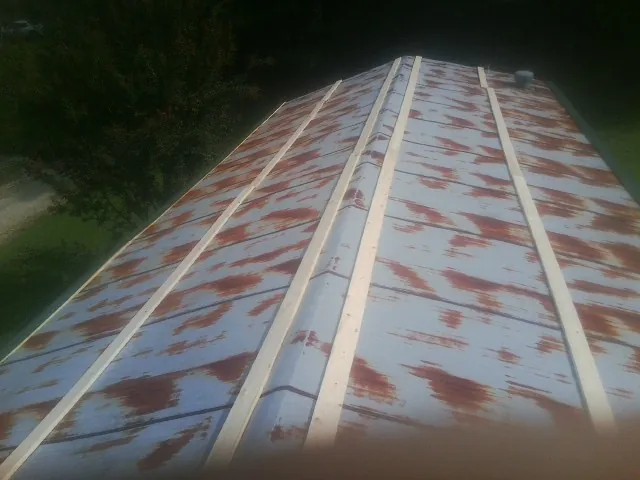 Rusted metal roof panels with new wood purlins before replacement — Storm Damage Roof Repair in Poquoson by Roofing Brothers