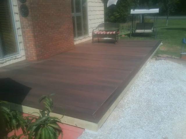 Freshly stained wood deck built against a brick home in Poquoson